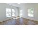 A sunlit bedroom is bright and spacious with beautiful hardwood floors and large, picturesque windows at 585 Sherwood Ne Rd, Atlanta, GA 30324