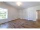 Sunlight fills this bedroom, highlighting the hardwood floors and trim around the large windows at 585 Sherwood Ne Rd, Atlanta, GA 30324