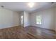 Well-lit bedroom featuring hardwood floors, a view of the outdoors and access to the Primary bathroom at 585 Sherwood Ne Rd, Atlanta, GA 30324