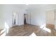 Bright bedroom with hardwood floors and multiple door openings to other rooms at 585 Sherwood Ne Rd, Atlanta, GA 30324