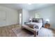 A bright, carpeted bedroom features a comfortable bed, a bench, and a view of the window at 585 Sherwood Ne Rd, Atlanta, GA 30324