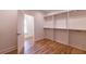 This walk-in closet has custom shelving, hanging racks, and wood floors at 585 Sherwood Ne Rd, Atlanta, GA 30324