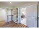 Hallway view of closet and connected bathroom space with hardwood floors at 585 Sherwood Ne Rd, Atlanta, GA 30324