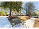 Exterior view of the home with a landscaped yard, mature trees, and a paved walkway at 585 Sherwood Ne Rd, Atlanta, GA 30324