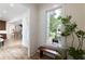 Foyer with a bench and plant with view through to kitchen at 585 Sherwood Ne Rd, Atlanta, GA 30324