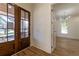 Elegant foyer with hardwood floors, double entry doors, and a view into the bright living area at 585 Sherwood Ne Rd, Atlanta, GA 30324