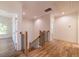 Upstairs hallway featuring hardwood floors, white trim and staircase with wood and iron railing at 585 Sherwood Ne Rd, Atlanta, GA 30324