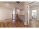 Hallway with wooden handrail leads to a bathroom with a light-filled window and modern fixtures at 585 Sherwood Ne Rd, Atlanta, GA 30324