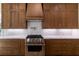 Kitchen featuring wood cabinets, stainless appliances and granite backsplash at 585 Sherwood Ne Rd, Atlanta, GA 30324