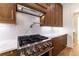 Kitchen with stainless steel stove, hood, and marble backsplash at 585 Sherwood Ne Rd, Atlanta, GA 30324