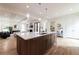 Open kitchen with center island, hardwood floors, and modern lighting at 585 Sherwood Ne Rd, Atlanta, GA 30324