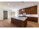 Kitchen island features stainless steel sink, pendant lights, quartz countertops and custom wood cabinets at 585 Sherwood Ne Rd, Atlanta, GA 30324