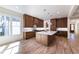 Well-lit kitchen featuring a large island, hardwood floors and wooden cabinets at 585 Sherwood Ne Rd, Atlanta, GA 30324