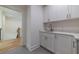 Convenient laundry area with white cabinets, sink and granite countertops at 585 Sherwood Ne Rd, Atlanta, GA 30324