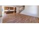 Open-concept living room with hardwood floors and a view of the kitchen and staircase at 585 Sherwood Ne Rd, Atlanta, GA 30324