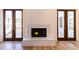 Living room with marble fireplace and access to the outside through wooden doors at 585 Sherwood Ne Rd, Atlanta, GA 30324