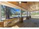 Covered porch with a stained wood ceiling, ceiling fans, and brick support columns at 585 Sherwood Ne Rd, Atlanta, GA 30324