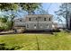 Rear view of a light gray two-story home with a two car garage and a spacious lawn at 585 Sherwood Ne Rd, Atlanta, GA 30324