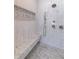 This luxurious shower is tiled and features a built-in bench and multiple shower heads at 585 Sherwood Ne Rd, Atlanta, GA 30324