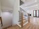 Wooden staircase with iron railings leads to an open living room with a fireplace at 585 Sherwood Ne Rd, Atlanta, GA 30324
