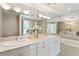 This spacious bathroom showcases dual sinks, modern light fixtures, and a tub and shower, creating a spa-like retreat at 700 Park Regency Ne Pl # 803, Atlanta, GA 30326