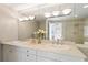 Elegant bathroom featuring dual sinks, a large mirror, stylish lighting, and a luxurious shower and tub combination at 700 Park Regency Ne Pl # 803, Atlanta, GA 30326