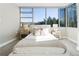 Bright bedroom with plush carpeting, a large window showcasing a city view, and two matching nightstands and lamps at 700 Park Regency Ne Pl # 803, Atlanta, GA 30326