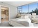 A serene bedroom that boasts an adjacent bathroom and expansive windows offering views of trees and bright sunlight at 700 Park Regency Ne Pl # 803, Atlanta, GA 30326