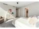 Spacious bedroom featuring light walls, a dresser, chair, and bathroom access, creating a comfortable, modern retreat at 700 Park Regency Ne Pl # 803, Atlanta, GA 30326