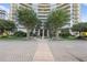 Exterior of building entrance with greenery, circular fountain, and a circular drop-off area at 700 Park Regency Ne Pl # 803, Atlanta, GA 30326