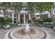 Exterior of building entrance, including manicured greenery, a circular fountain, and covered drop-off area at 700 Park Regency Ne Pl # 803, Atlanta, GA 30326