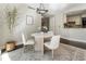 Dining area adjacent to the kitchen with modern lighting and comfortable seating for elegant meals at 700 Park Regency Ne Pl # 803, Atlanta, GA 30326
