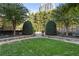 Lovely green space with manicured bushes and landscaping, including a walkway and some shade trees at 700 Park Regency Ne Pl # 803, Atlanta, GA 30326