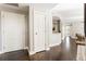 Clean hallway with hardwood flooring and a view into the stylishly decorated living space at 700 Park Regency Ne Pl # 803, Atlanta, GA 30326