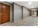 Hallway showcasing a wooden door, textured walls, and patterned carpet leading to a brighter area at 700 Park Regency Ne Pl # 803, Atlanta, GA 30326