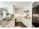 Well-lit kitchen features granite countertops, white cabinets, and stainless steel appliances for modern cooking at 700 Park Regency Ne Pl # 803, Atlanta, GA 30326