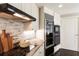 Kitchen with granite countertops, backsplash, updated cabinets, and stainless steel appliances at 700 Park Regency Ne Pl # 803, Atlanta, GA 30326