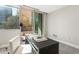 Well-lit office with large windows and a dark desk with decor at 700 Park Regency Ne Pl # 803, Atlanta, GA 30326