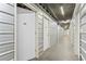 Hallway full of storage units, all individually numbered and secured with doors, and concrete floors at 700 Park Regency Ne Pl # 803, Atlanta, GA 30326