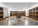 Spacious wine cellar featuring stone floors, a table with seating, and individual wine storage cabinets at 700 Park Regency Ne Pl # 803, Atlanta, GA 30326