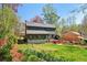 Green home exterior with a deck, a screened-in porch, and a well-maintained lawn at 2411 Mitchell Ne Rd, Marietta, GA 30062