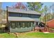 Green home exterior features a deck, screened-in porch, and well-maintained lawn at 2411 Mitchell Ne Rd, Marietta, GA 30062