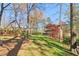 Spacious backyard with swing set, mature trees, and lush greenery offers an ideal play and relaxation area at 2411 Mitchell Ne Rd, Marietta, GA 30062