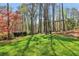 Spacious, well-manicured backyard boasts mature trees and a swing set, perfect for outdoor enjoyment at 2411 Mitchell Ne Rd, Marietta, GA 30062