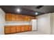 Basement kitchenette with wood cabinets, white countertops, and a white refrigerator at 2411 Mitchell Ne Rd, Marietta, GA 30062