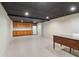 Open basement area featuring a kitchenette, finished ceiling, and tile flooring at 2411 Mitchell Ne Rd, Marietta, GA 30062