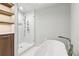 Bright bathroom featuring a soaking tub, glass-enclosed shower, and stylish shelving with ambient lighting at 2411 Mitchell Ne Rd, Marietta, GA 30062