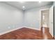 Neutral bedroom boasts hardwood floors, neutral paint, and an ensuite bathroom at 2411 Mitchell Ne Rd, Marietta, GA 30062
