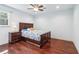 Bright bedroom features hardwood floors, ceiling fan, and a side table with a lamp at 2411 Mitchell Ne Rd, Marietta, GA 30062