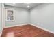 Comfortable bedroom with hardwood floors, a window for natural light, and neutral wall paint at 2411 Mitchell Ne Rd, Marietta, GA 30062